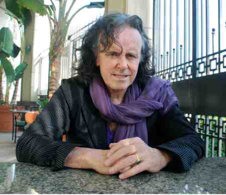 Donovan at table publicty shot #2