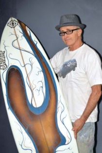 Lanny Shuler with a sample of his surfboard art.